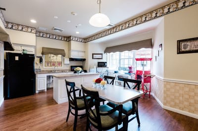 Bright common area kitchen with dining table