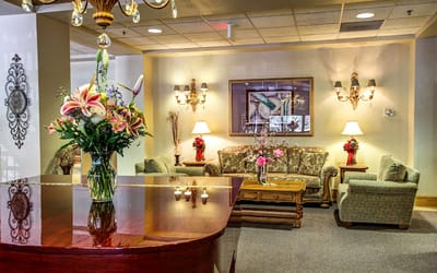 Interior lounge area with seating and floral arrangements
