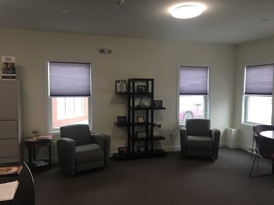 Interior of a common area with chairs and informational shelves