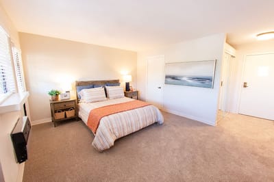 Cozy, well-lit bedroom in a senior living facility