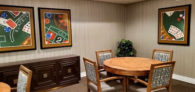 Interior game room with a poker table and artwork