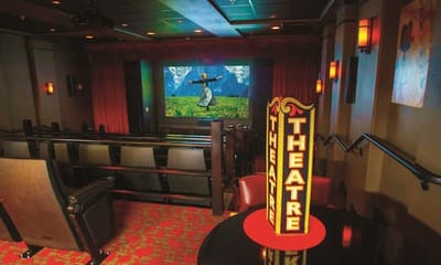 Inside the facility's theatre room with seating and a movie screen