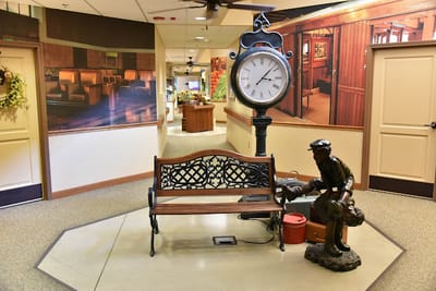 Decorative clock and bench in a hallway interior