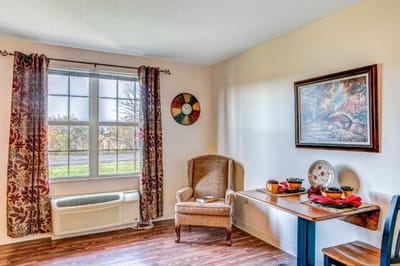 Bright, cozy room with seating and decor