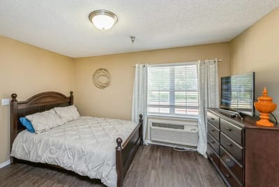 Cozy private bedroom with a bed and dresser