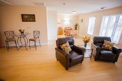 Cozy private room with seating and a bed