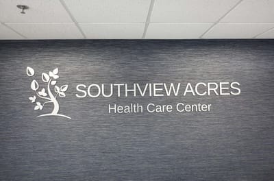 Facility logo on a blue textured wall