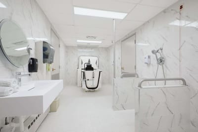 A modern assisted bathing room with marble walls