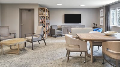 Living room area with comfortable seating and bookshelves