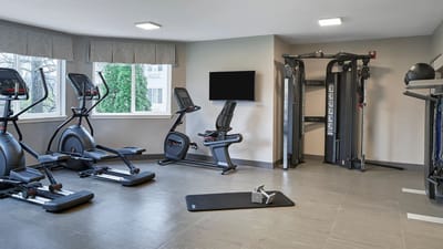 Fitness room with exercise equipment in a senior living facility