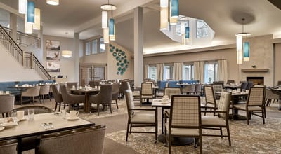 Bright dining room with tables set for meals