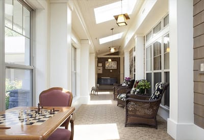 Bright interior hallway with seating and chess table
