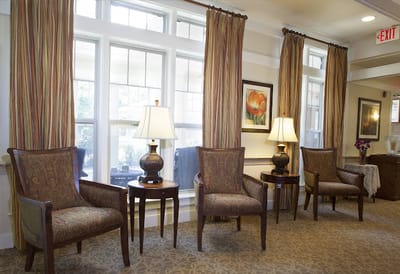 Bright common area with chairs and lamps