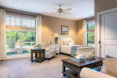 A well-lit and furnished resident room with a view