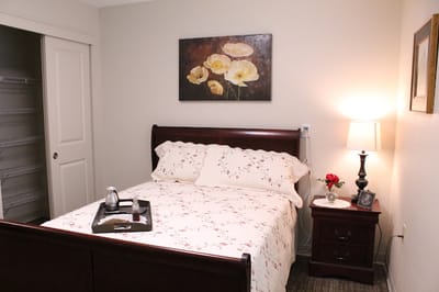 Cozy private room with a floral bedspread and artwork