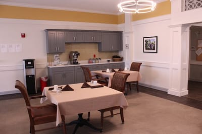 Dining area with neatly set tables and a coffee station