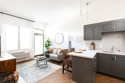 Bright, modern interior of a resident unit with a living area and kitchen