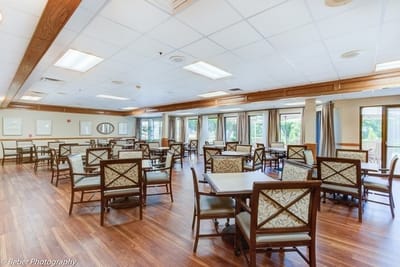Bright dining room with tables and chairs for residents