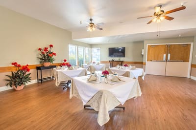 Dining room set up for a meal service with flowers
