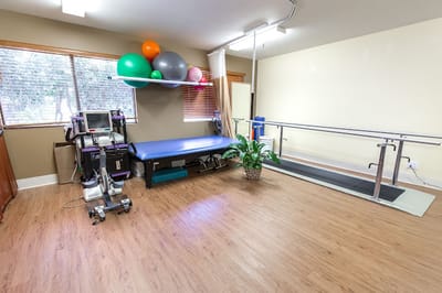 Physical therapy room with exercise equipment and balls