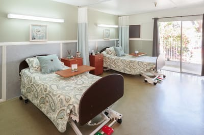 Bright interior view of a resident room with two beds