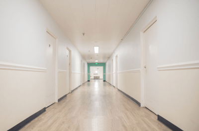 A well-lit hallway with several doors