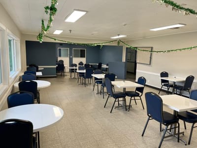 Dining area with tables and chairs in a communal space
