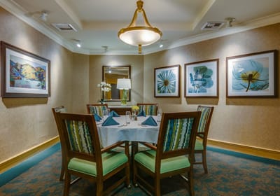 Elegant dining area with framed artwork and table settings