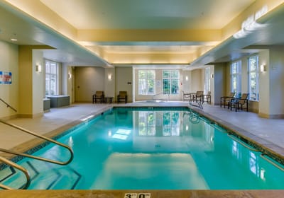 Indoor swimming pool area with lounge chairs