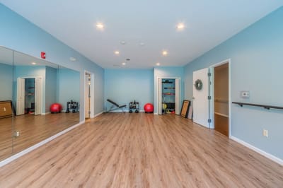Bright and spacious activity room with exercise equipment