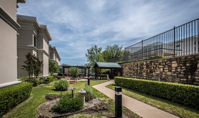 Well-maintained garden path with seating areas