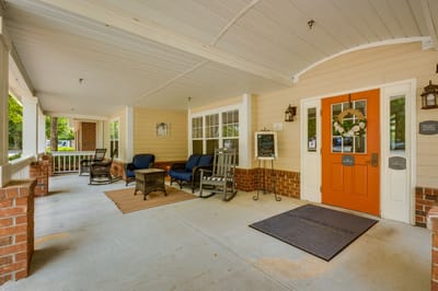 Welcoming front porch with rocking chairs and comfortable seating