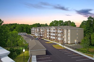 Exterior view of Glenmont Abbey Village at sunset