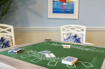 Cards and poker chips on a gaming table in an activity room