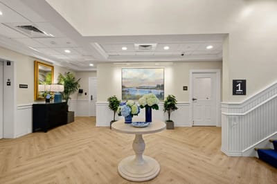 Bright interior lobby with floral arrangements and artwork