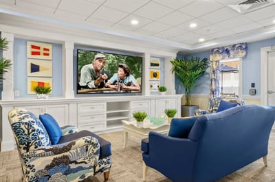 Comfortable common area with a movie screen and seating