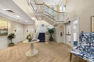 Bright and welcoming lobby area with stairs and seating