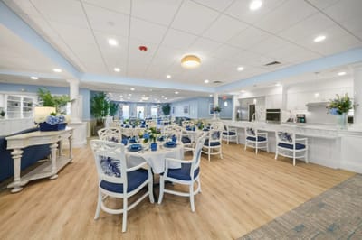 Bright dining area with blue decor and flower arrangements