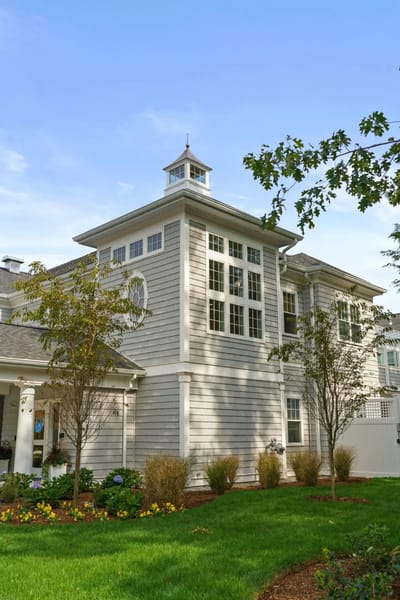 Exterior view of a senior living facility surrounded by landscaping