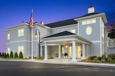 Exterior view of Duxbury House Memory Care Residence at dusk