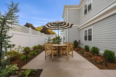 Outdoor seating area with table and umbrella in a garden