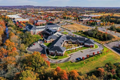 Aerial view of a senior living community surrounded by trees