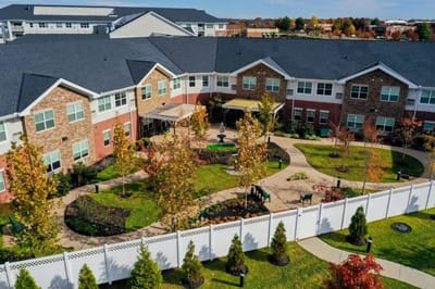 Aerial view of landscaped gardens and pathways at senior living facility