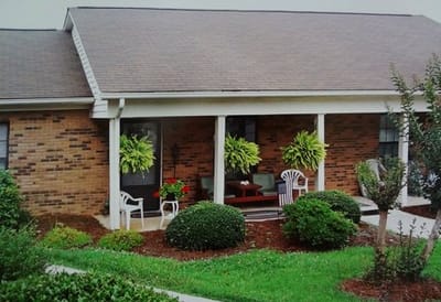 Exterior view of a porch with plants and seating