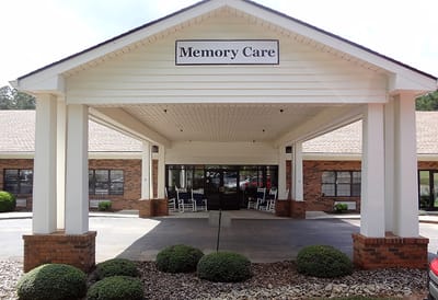 Entrance of a Memory Care facility with rocking chairs
