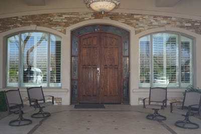 Entrance with wooden doors and seating area