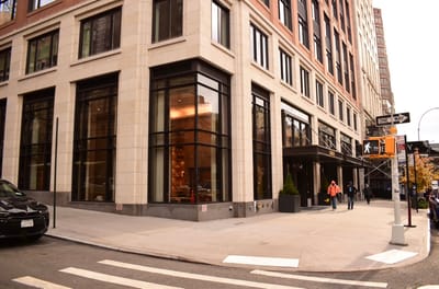 Building exterior with residents walking nearby