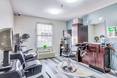 Bright hair salon area with styling chairs and mirrors