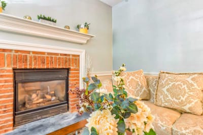 Cozy living room with a fireplace and floral decor
