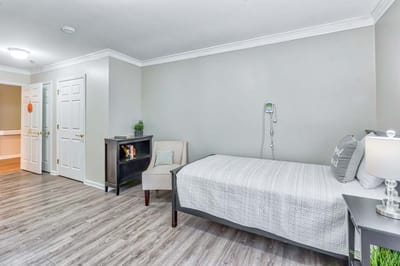 Private resident room with a bed and chair